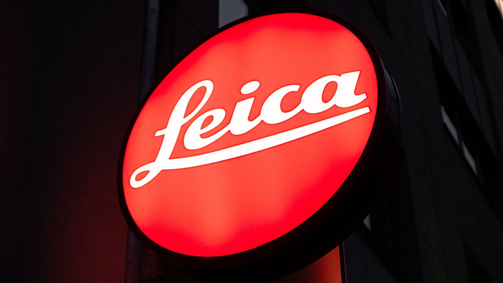 Illuminated facade signage at twilight